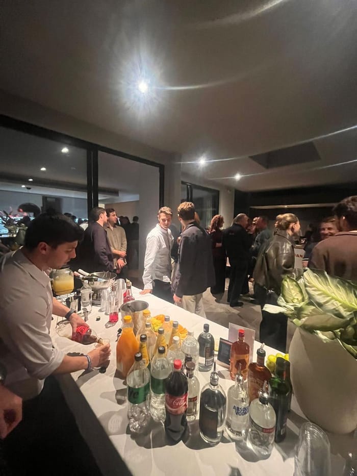 Bartender serving guests at a busy private party